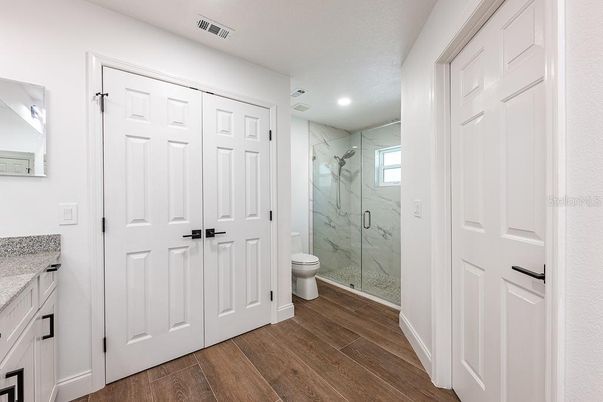 Bathroom, Glass Shower, Interior, Marble Walls, Recessed Lighting, Wood Texture Flooring