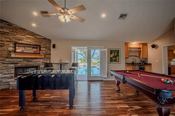 Billiard Table, Fireplace, Game Room, Interior, Recessed Lighting, Stone Walls, Wood Texture Flooring