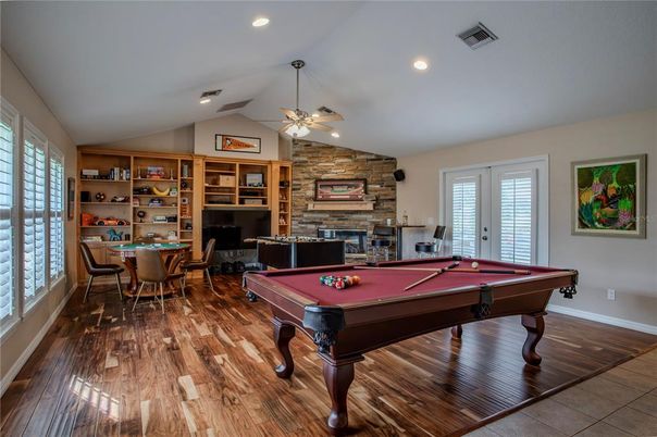 Billiard Table, Dining room, Fireplace, Game Room, Interior, Recessed Lighting, Stone Walls, Wood Texture Flooring