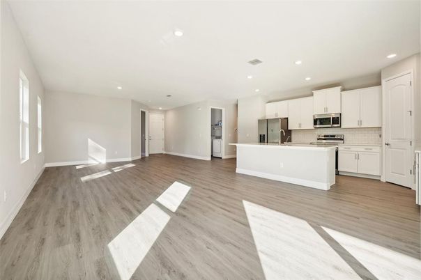 Empty room, Interior, Kitchen, Recessed Lighting, Stainless Steel Appliances, Wood Texture Flooring