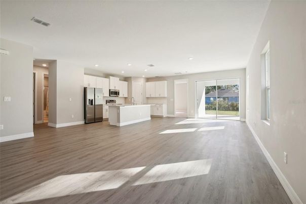 Empty room, Interior, Kitchen, Recessed Lighting, Stainless Steel Appliances, Wood Texture Flooring