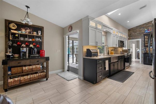 Interior, Kitchen, Pendant Lights, Recessed Lighting, Stainless Steel Appliances, Stone Walls, Wood Texture Flooring