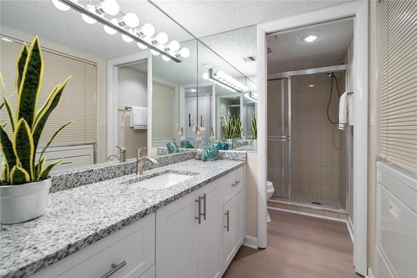 Bathroom, Dual Sink Vanities, Glass Shower, Interior, Recessed Lighting, Wood Texture Flooring