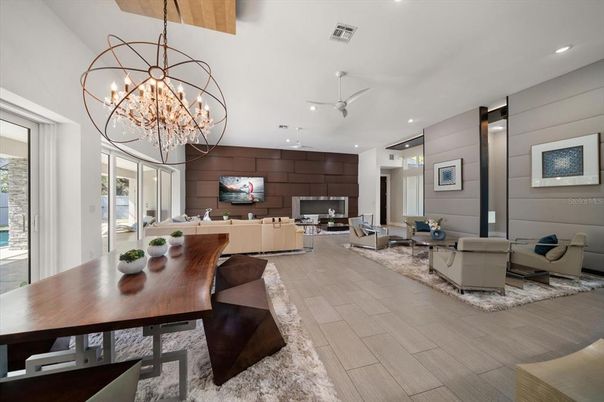 Chandelier, Dining room, Fireplace, Interior, Living room, Pendant Lights, Recessed Lighting, Wood Texture Flooring, Wooden Walls