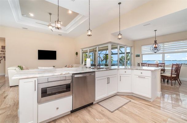 Dining room, Interior, Kitchen, Pendant Lights, Recessed Lighting, Stainless Steel Appliances, Water, Wood Texture Flooring