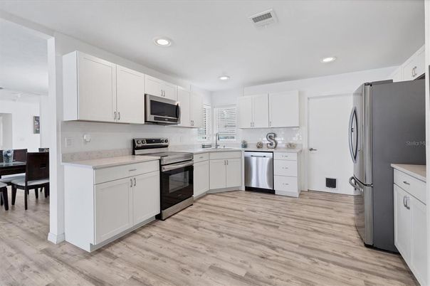 Dining room, Interior, Kitchen, Recessed Lighting, Stainless Steel Appliances, Wood Texture Flooring