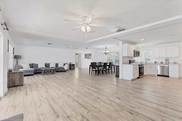 Chandelier, Dining room, Interior, Kitchen, Living room, Recessed Lighting, Stainless Steel Appliances, Wood Texture Flooring