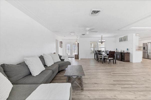 Chandelier, Dining room, Interior, Kitchen, Living room, Pendant Lights, Stainless Steel Appliances, Wood Texture Flooring