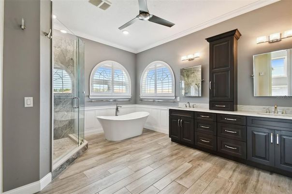 Bathroom, Dual Sink Vanities, Free Standing Baths, Glass Shower, Interior, Recessed Lighting, Wood Texture Flooring