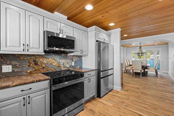 Chandelier, Dining room, Interior, Kitchen, Recessed Lighting, Stainless Steel Appliances, Wooden Ceilings, Wood Texture Flooring