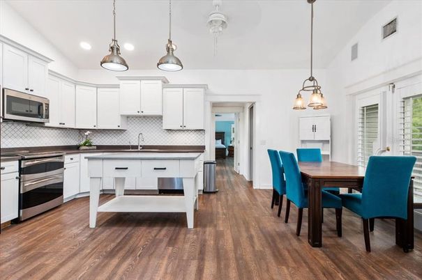 Dining room, Interior, Kitchen, Pendant Lights, Recessed Lighting, Stainless Steel Appliances, Wood Texture Flooring