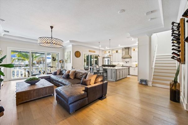 Chandelier, Dining room, Interior, Kitchen, Living room, Pendant Lights, Recessed Lighting, Stainless Steel Appliances, Wood Texture Flooring
