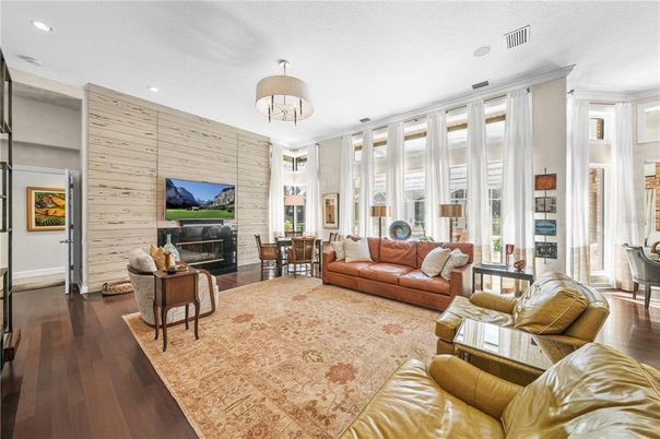 Dining room, Fireplace, Interior, Living room, Recessed Lighting, Stone Walls, Wood Texture Flooring