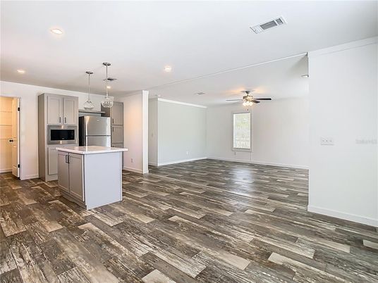 Empty room, Interior, Kitchen, Pendant Lights, Recessed Lighting, Stainless Steel Appliances, Wood Texture Flooring