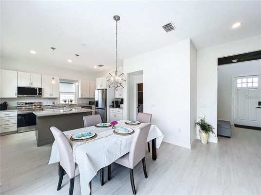 Dining room, Interior, Kitchen, Pendant Lights, Recessed Lighting, Stainless Steel Appliances, Wood Texture Flooring