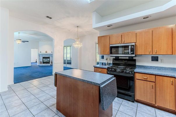 Chandelier, Fireplace, Interior, Kitchen, Recessed Lighting, Stainless Steel Appliances