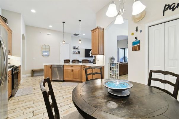 Dining room, Interior, Kitchen, Pendant Lights, Recessed Lighting, Stainless Steel Appliances, Wood Texture Flooring