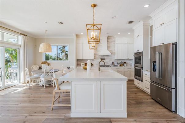Chandelier, Dining room, Interior, Kitchen, Pendant Lights, Recessed Lighting, Stainless Steel Appliances, Wood Texture Flooring