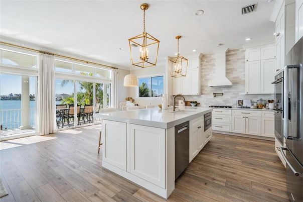 Dining room, Interior, Kitchen, Pendant Lights, Recessed Lighting, Stainless Steel Appliances, Water, Wood Texture Flooring