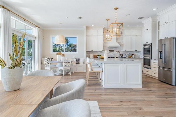 Chandelier, Dining room, Interior, Kitchen, Pendant Lights, Recessed Lighting, Stainless Steel Appliances, Wood Texture Flooring