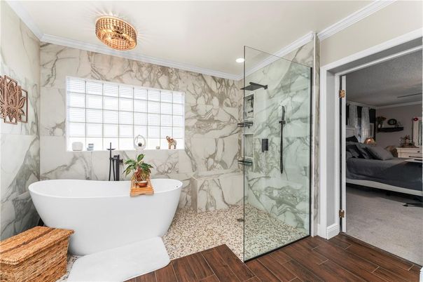 Bathroom, Free Standing Baths, Glass Shower, Interior, Marble Walls, Recessed Lighting, Wood Texture Flooring