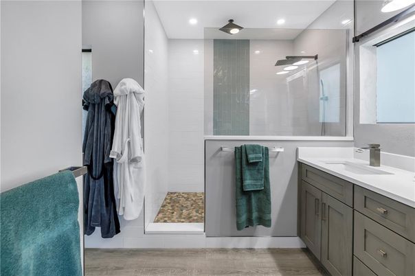 Bathroom, Dual Sink Vanities, Glass Shower, Interior, Recessed Lighting, Wood Texture Flooring