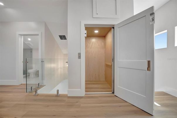 Elevator, Interior, Recessed Lighting, Wood Texture Flooring, Wooden Walls