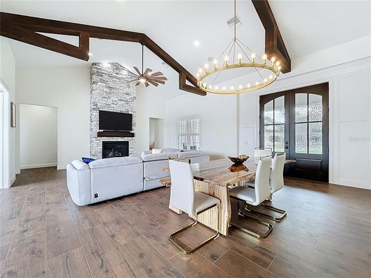 Dining room, Fireplace, Interior, Living room, Pendant Lights, Recessed Lighting, Stone Walls, Wooden Beams, Wood Texture Flooring
