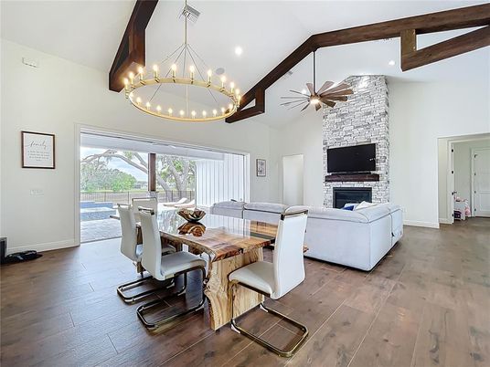 Dining room, Fireplace, Interior, Living room, Pendant Lights, Recessed Lighting, Stone Walls, Wooden Beams, Wood Texture Flooring