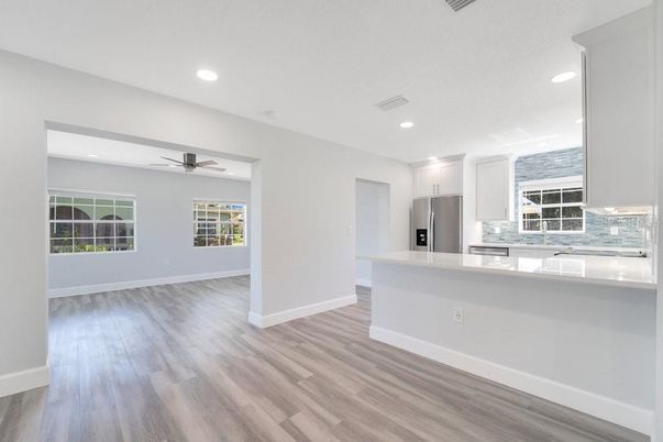 Empty room, Interior, Kitchen, Recessed Lighting, Stainless Steel Appliances, Wood Texture Flooring