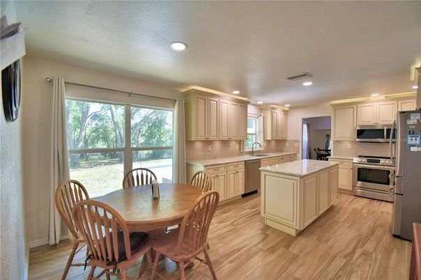 Dining room, Interior, Kitchen, Recessed Lighting, Stainless Steel Appliances, Wood Texture Flooring