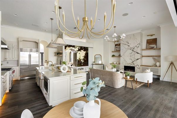 Chandelier, Fireplace, Interior, Kitchen, Living room, Marble Walls, Pendant Lights, Recessed Lighting, Stainless Steel Appliances, Wood Texture Flooring