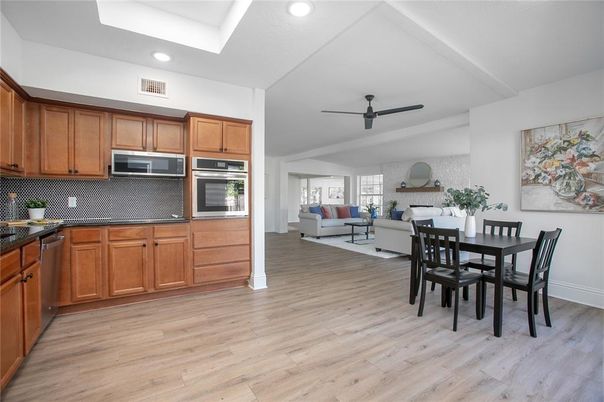 Dining room, Interior, Kitchen, Living room, Recessed Lighting, Stainless Steel Appliances, Wood Texture Flooring