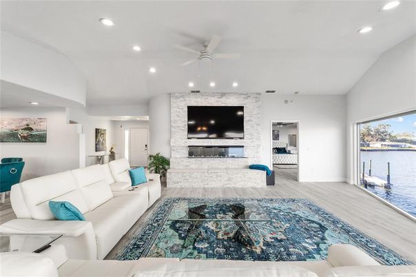 Fireplace, Interior, Living room, Recessed Lighting, Stone Walls, Water, Wood Texture Flooring