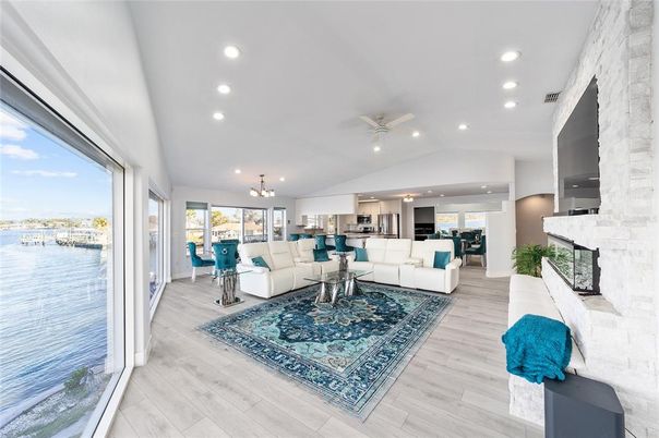 Fireplace, Interior, Kitchen, Living room, Pendant Lights, Recessed Lighting, Stone Walls, Water, Wood Texture Flooring