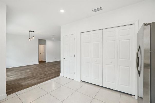 Empty room, Interior, Kitchen, Pendant Lights, Recessed Lighting, Stainless Steel Appliances, Wood Texture Flooring