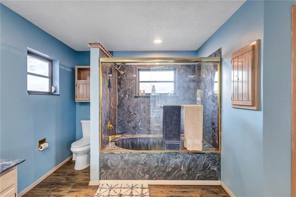 Bathroom, Glass Shower, Interior, Marble Walls, Recessed Lighting, Wood Texture Flooring