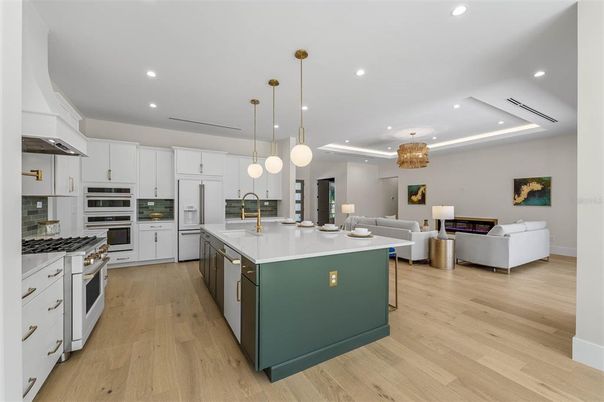 Chandelier, Interior, Kitchen, Living room, Pendant Lights, Recessed Lighting, Stainless Steel Appliances, Wood Texture Flooring