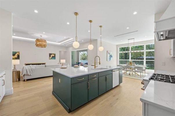 Chandelier, Dining room, Interior, Kitchen, Living room, Pendant Lights, Recessed Lighting, Stainless Steel Appliances, Wood Texture Flooring