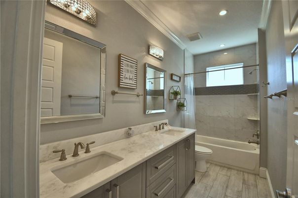 Bathroom, Dual Sink Vanities, Interior, Marble Walls, Recessed Lighting, Wood Texture Flooring