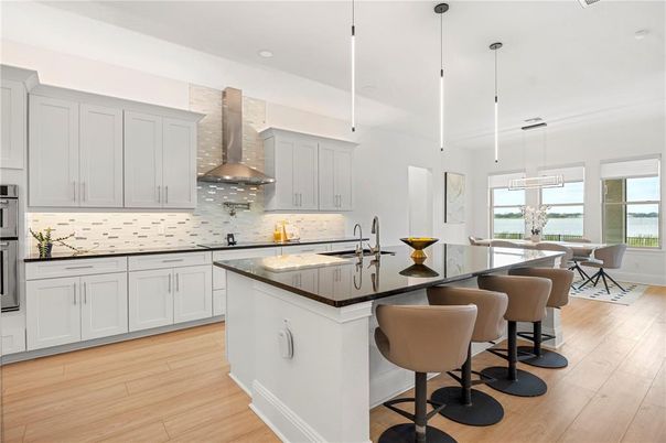 Dining room, Interior, Kitchen, Pendant Lights, Recessed Lighting, Stainless Steel Appliances, Water, Wood Texture Flooring