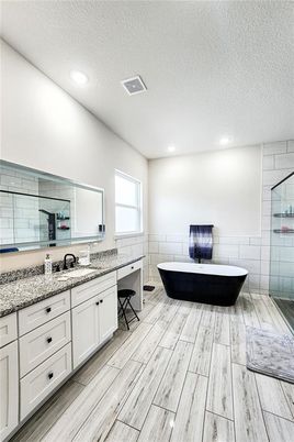 Bathroom, Dual Sink Vanities, Free Standing Baths, Glass Shower, Interior, Recessed Lighting, Wood Texture Flooring