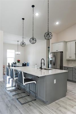 Chandelier, Dining room, Interior, Kitchen, Pendant Lights, Recessed Lighting, Stainless Steel Appliances, Wood Texture Flooring