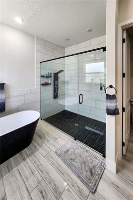 Bathroom, Free Standing Baths, Glass Shower, Interior, Recessed Lighting, Wood Texture Flooring