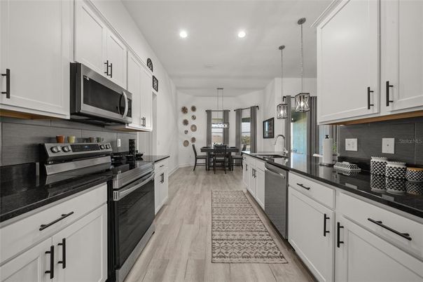 Dining room, Interior, Kitchen, Pendant Lights, Recessed Lighting, Stainless Steel Appliances, Wood Texture Flooring