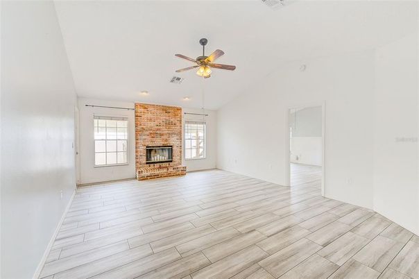 Empty room, Fireplace, Interior, Recessed Lighting, Stone Walls, Wood Texture Flooring