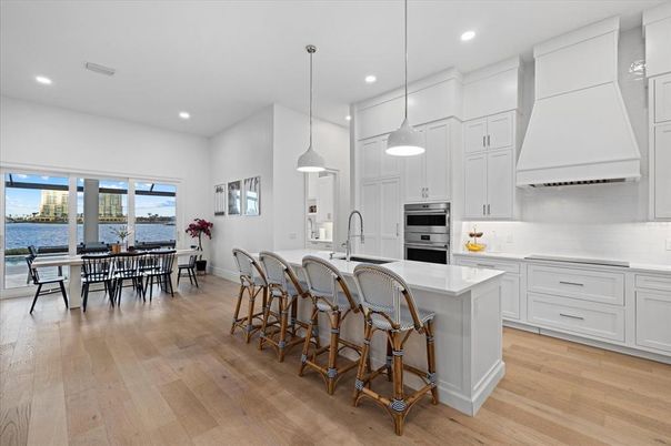 Dining room, Interior, Kitchen, Pendant Lights, Recessed Lighting, Stainless Steel Appliances, Water, Wood Texture Flooring
