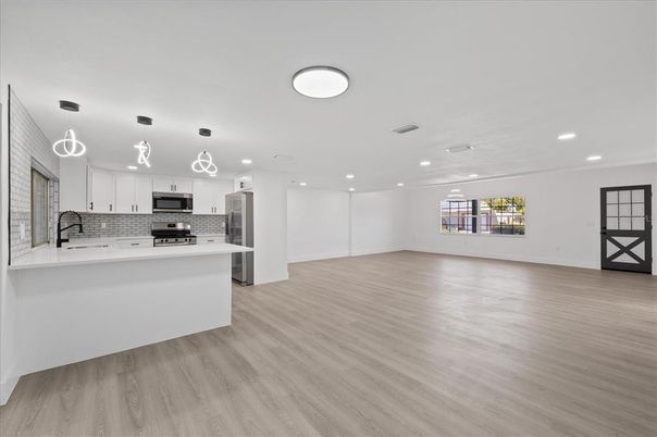Interior, Kitchen, Pendant Lights, Recessed Lighting, Stainless Steel Appliances, Wood Texture Flooring
