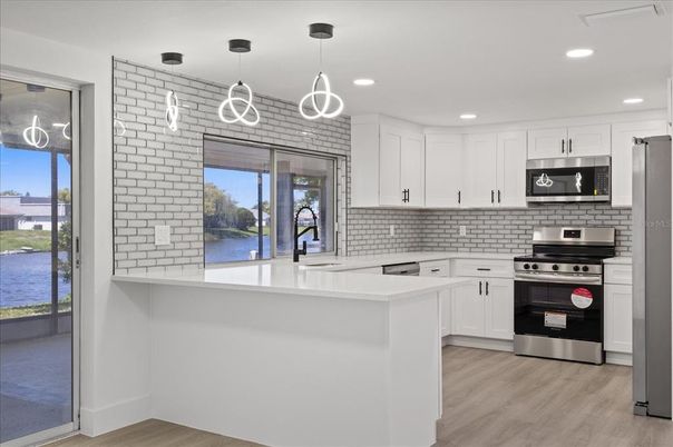 Interior, Kitchen, Pendant Lights, Recessed Lighting, Stainless Steel Appliances, Wood Texture Flooring