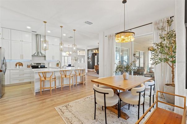 Chandelier, Dining room, Interior, Kitchen, Pendant Lights, Recessed Lighting, Stainless Steel Appliances, Wood Texture Flooring
